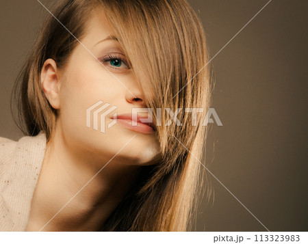 portrait of pretty girl with hair fringe covered eye portrait of pretty girl with hair fringe covered eye 113323983