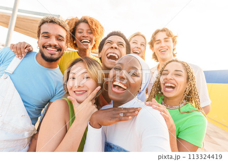 African woman taking selfie with multi-ethnic friends outdoors African woman taking selfie with multi-ethnic friends outdoors 113324419