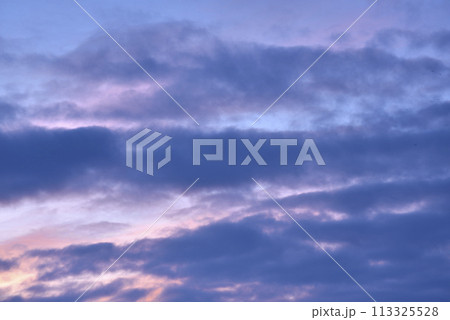 Evening sunset sky. Light blue yellow clouds in the sky. 113325528