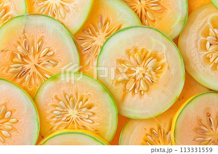 Close up of melon slices. Whole background. Top view. Close up of melon slices. Whole background. Top view. 113331559