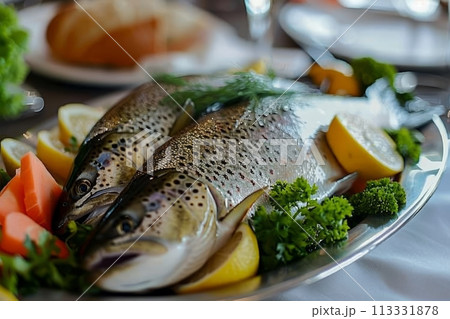Red trout fish in a dish with seasonings and herbs on the table, healthy sea fish 113331878