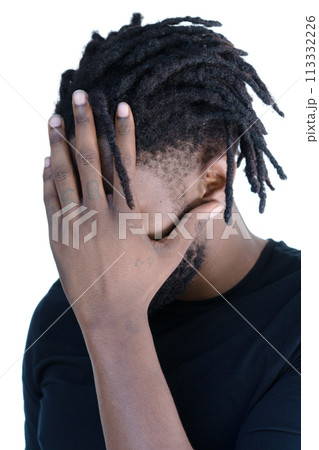 A portrait of an African American man covering his face with his palm 113332226