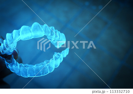 Invisible teeth aligner on light background 113332710