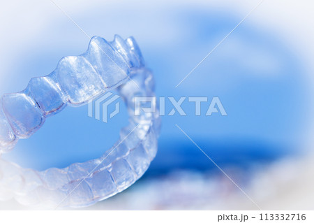 Invisible teeth aligner on light background Invisible teeth aligner on light background 113332716