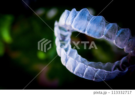 Invisible teeth aligner on light background Invisible teeth aligner on light background 113332717