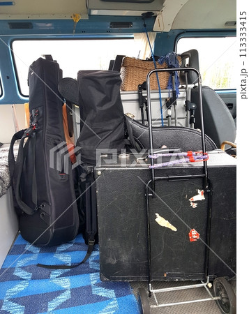 The instruments in the cases are loaded into the van. 113333415