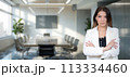 A young woman against a blurry background of a negotiation room. 113334460