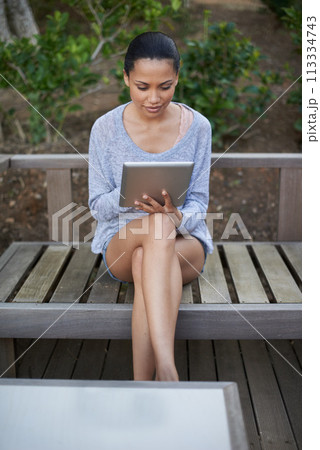 Park bench, tablet and relax woman reading ebook, research article or social network blog. Outdoor wellness, nature and person with email, tech and surfing internet for online story on media app 113334743