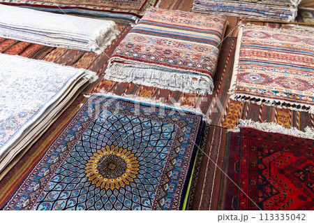 Assortment of oriental silk carpets for sale with colorful geometric patterns Assortment of oriental silk carpets for sale with colorful geometric patterns 113335042