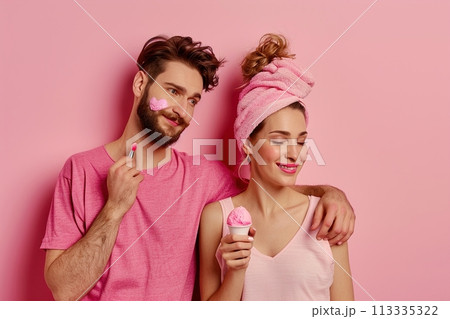 A man and a woman are posing for a picture with an ice cream cone 113335322