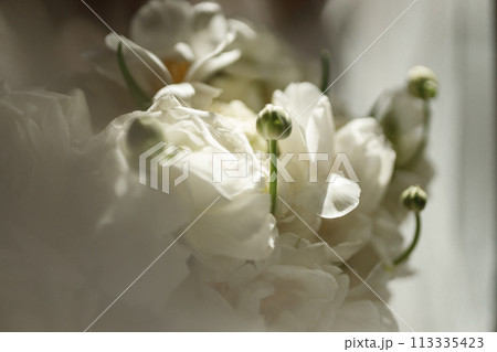 Bride's bouquet of white peonies with wedding rings Bride's bouquet of white peonies with wedding rings 113335423