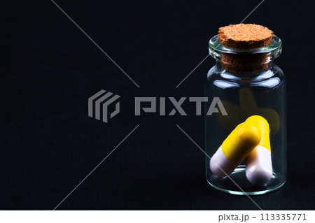 glass jar with colorful pills glass jar with colorful pills 113335771