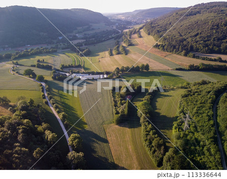 Aerial view on small town - colorful fields and trees in autumn Aerial view on small town - colorful fields and trees in autumn 113336644