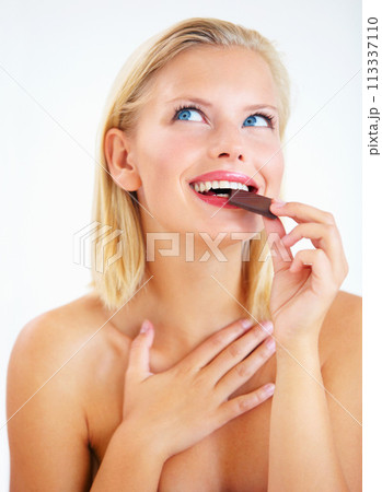 Studio happiness, woman thinking and eating chocolate, delicious snack or look at sugar product, candy or dessert advertising. Antioxidants benefits, cacao sweets or wellness girl on white background 113337110