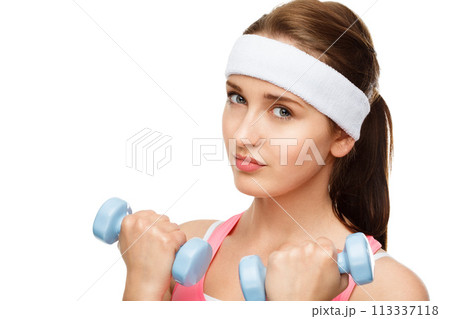 Determined to build these biceps. a young woman using weights against a studio background. Determined to build these biceps. a young woman using weights against a studio background. 113337118