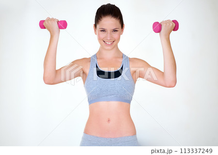 Woman, strong pose and portrait with dumbbells in studio, wellness and fitness for weight loss with exercise. Young person, flex and face with hand weights for muscle training and white background Woman, strong pose and portrait with dumbbells in studio, wellness and fitness for weight loss with exercise. Young person, flex and face with hand weights for muscle training and white background 113337249