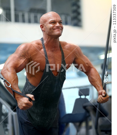 Body builder, exercise pull and man in a gym with power, weightlifting machine and strength workout. Muscle, strain and strong athlete with training for bodybuilder fitness and wellness for sport 113337309