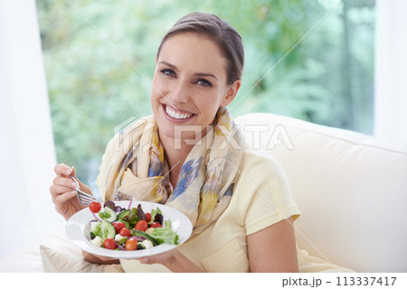 Woman, eating salad and food for diet, vegetables and lunch with happiness in portrait. Nutrition, wellness and healthy vegan meal for cholesterol with smile, detox and snack for dinner at home Woman, eating salad and food for diet, vegetables and lunch with happiness in portrait. Nutrition, wellness and healthy vegan meal for cholesterol with smile, detox and snack for dinner at home 113337417