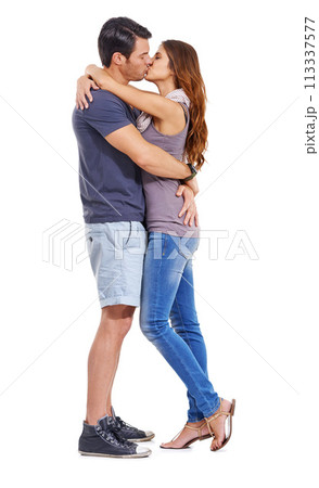 Hug, love and couple kiss in studio for care, romance or commitment to marriage isolated on a white background. Man, woman and touch lips to embrace for connection, support and relationship on mockup 113337577