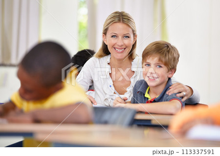 Portrait of happy teacher, child or writing in classroom for learning, education and helping for development. Woman teaching, hug or boy student with knowledge, support or notebook at middle school 113337591