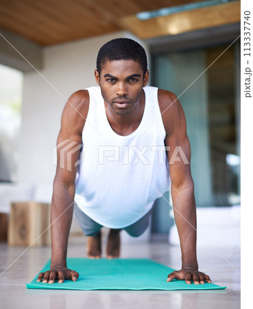 Fitness, portrait and black man do yoga on floor for wellness, flexibility and balance for healthy body. Training, pilates and person on sports mat for stretching, workout and exercise in living room Fitness, portrait and black man do yoga on floor for wellness, flexibility and balance for healthy body. Training, pilates and person on sports mat for stretching, workout and exercise in living room 113337740