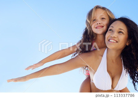 Happy mother, little girl and piggyback in sun at beach for bonding, vacation or outdoor holiday together on mockup. Mom, child or daughter smile for love, support or summer on blue sky background Happy mother, little girl and piggyback in sun at beach for bonding, vacation or outdoor holiday together on mockup. Mom, child or daughter smile for love, support or summer on blue sky background 113337786