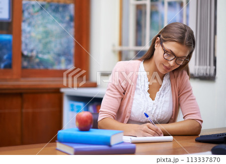 School teacher, woman writing and planning in classroom, brainstorming and ideas for education. Female person, knowledge and information for learning, contemplating academic and notepad for notes School teacher, woman writing and planning in classroom, brainstorming and ideas for education. Female person, knowledge and information for learning, contemplating academic and notepad for notes 113337870