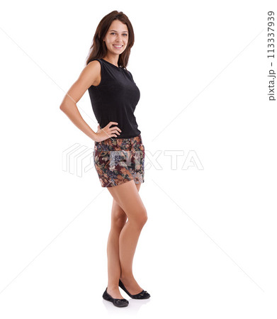 Portrait, fashion and happy with trendy woman in studio isolated on white background for style. Model, clothes and smile with young natural person looking confident in clothing or shorts outfit 113337939
