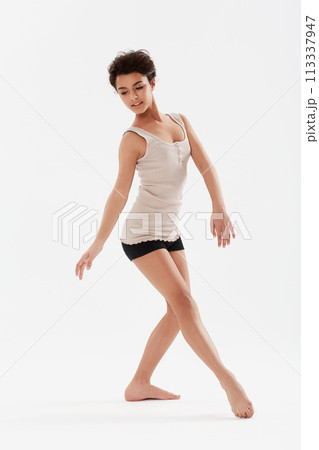 Dance, ballet and woman on a white background for performance, fitness and training for theatre. Ballerina, dancer and isolated person pose for balance, creative routine and practice in studio Dance, ballet and woman on a white background for performance, fitness and training for theatre. Ballerina, dancer and isolated person pose for balance, creative routine and practice in studio 113337947