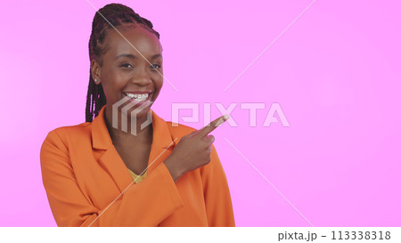 Black woman, smile and pointing for advertising in studio on blank mock up space for presentation. Portrait, happy or person with promotion for business, marketing or offer on pink background 113338318