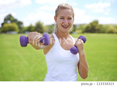 Woman, portrait and dumbbells, weightlifting for exercise and muscle, athlete outdoor for sport and bodybuilding. Healthy, fitness equipment and strong in park with bodybuilder and workout with smile Woman, portrait and dumbbells, weightlifting for exercise and muscle, athlete outdoor for sport and bodybuilding. Healthy, fitness equipment and strong in park with bodybuilder and workout with smile 113338323