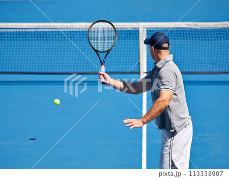 Fitness, man and tennis on court with serve, competition and performance outdoor with sport and energy. Athlete, player and ball on turf for training, exercise and racket with skill, game and hobby 113338907