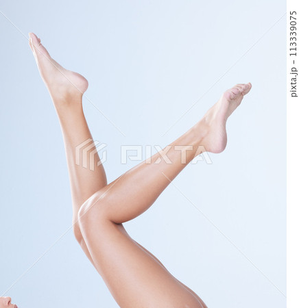 Body care, woman and legs in studio for hair removal, epilation and cosmetology for wellness and laser. Person, depilation and shaving routine for cosmetic, skincare and waxing on blue background 113339075