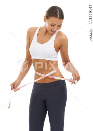 Woman, lose weight and happy with results on measuring tape in studio or white background. Fitness, check and person reading measurement and size of body for health, wellness and progress in goals 113339147
