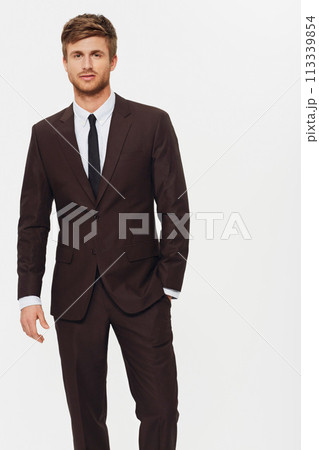 Portrait, corporate and a young business man in studio on a white background for the start of his career. Company, work or job with a confident employee in a trendy suit as a formal professional 113339854