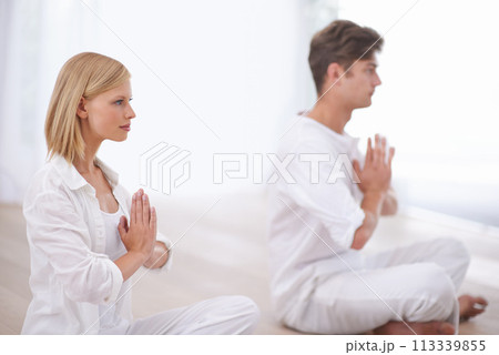 Praying hands, meditation and couple on a floor for peace, balance and spirituality in their home together. Balance, profile and people in a living room for zen, stress relief or holistic self care 113339855