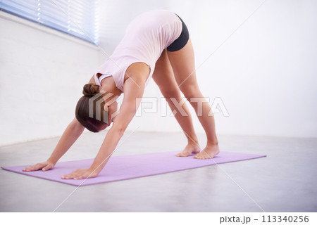 Yoga, downward dog and woman with body stretching for fitness, natural exercise and balance in home. Workout, pilates and healthy girl on mat for morning muscle warm up, wellness or self care mission Yoga, downward dog and woman with body stretching for fitness, natural exercise and balance in home. Workout, pilates and healthy girl on mat for morning muscle warm up, wellness or self care mission 113340256