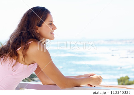 Happy, balcony and woman by ocean relax for summer holiday, vacation and weekend. Travel, hotel resort and person with smile for adventure, happiness and freedom with scenic view of nature and sea 113340323