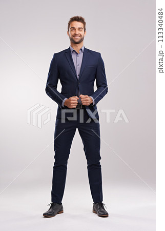Portrait, studio and happy businessman with confidence, corporate fashion and pride. Salesman, consultant or entrepreneur man in business suit with stylish gentleman clothes on white background 113340484