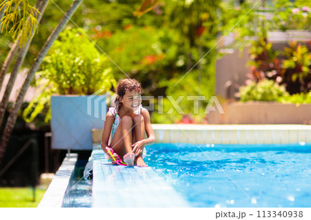 Child in swimming pool on ring toy. Kids swim. Child in swimming pool on ring toy. Kids swim. 113340938