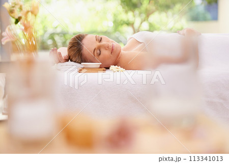Woman, relax and sleeping with towel at spa in stress relief, zen or health and wellness on massage table. Calm female person enjoying luxury skincare, body treatment or relaxation at peaceful resort Woman, relax and sleeping with towel at spa in stress relief, zen or health and wellness on massage table. Calm female person enjoying luxury skincare, body treatment or relaxation at peaceful resort 113341013