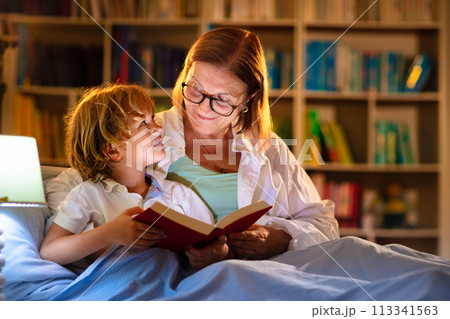 Mom and child reading book in bed. Kids read. Mom and child reading book in bed. Kids read. 113341563