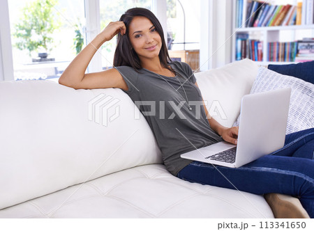 Portrait, woman and laptop with smile in lounge, working or relaxing or break on couch. Female person, watching or typing in computer, technology and connectivity for results in living room or house 113341650