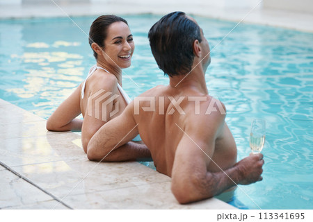 Vacation, hotel and couple laugh in pool for swimming, man and woman together with happiness for honeymoon. Resort, female person and smile for love in marriage, bonding and guy with champagne Vacation, hotel and couple laugh in pool for swimming, man and woman together with happiness for honeymoon. Resort, female person and smile for love in marriage, bonding and guy with champagne 113341695