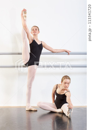 Dancing, girls and teenager in rehearsal for ballet with fitness, happy or artistic performance routine. Dance studio, friends or creative practice in preparation for entertainment, training or class 113341720