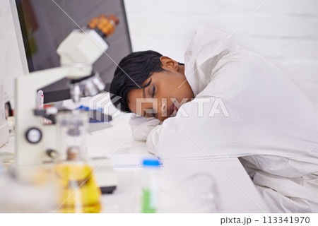 Sleeping, tired and woman scientist in laboratory working overtime on pharmaceutical research. Exhausted, fatigue and female biology researcher with nap for burnout with medical project or study. 113341970