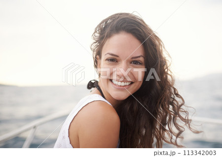 Woman, portrait and smile on yacht in outdoors, happy and travel to ocean on summer holiday. Female person, cruise and relax on boat transportation in water, peace and sailing in Italy on vacation 113342003
