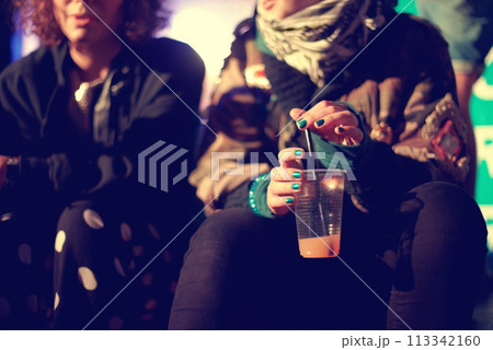 Hands, drink and friends outdoor at a music festival together for an event, show or performance. Cup, cocktail and alcohol with a person at a night carnival for celebration or entertainment closeup Hands, drink and friends outdoor at a music festival together for an event, show or performance. Cup, cocktail and alcohol with a person at a night carnival for celebration or entertainment closeup 113342160