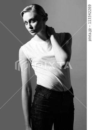 Woman, black and white in studio for vintage fashion or classic aesthetic by gray background with light. Isolated model, edgy outfit or clothes with retro style, lady or pose with art deco in studio Woman, black and white in studio for vintage fashion or classic aesthetic by gray background with light. Isolated model, edgy outfit or clothes with retro style, lady or pose with art deco in studio 113342269