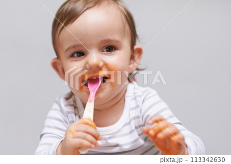 Eating, cute and boy baby in chair with vegetable food for child development at home. Sweet, nutrition and hungry young kid or toddler enjoying healthy lunch, dinner or supper meal at house. 113342630